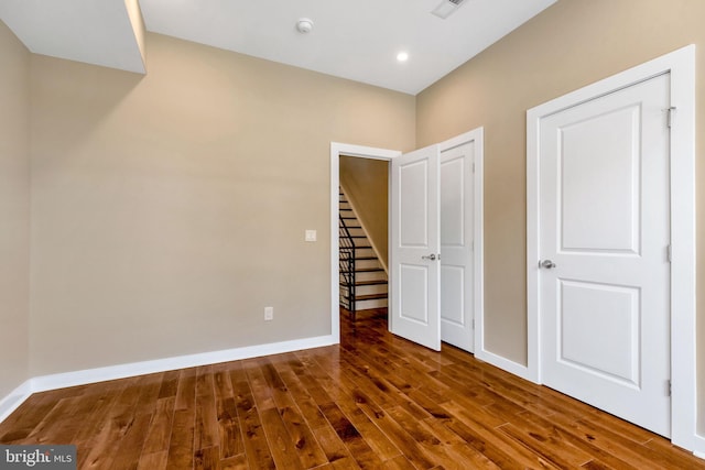 unfurnished bedroom with hardwood / wood-style flooring