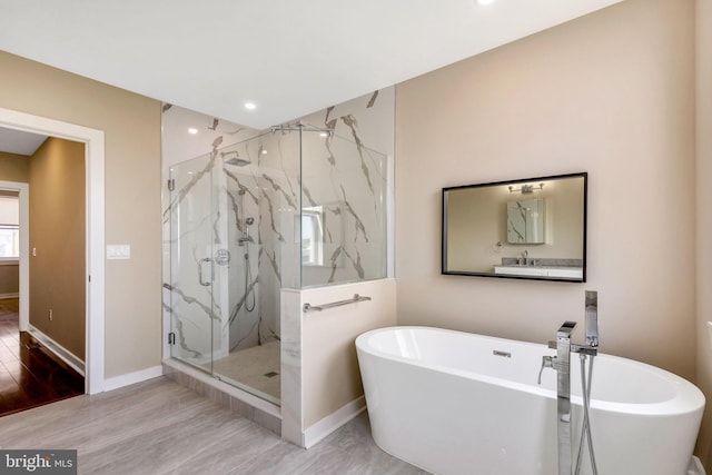 bathroom with plus walk in shower and wood-type flooring