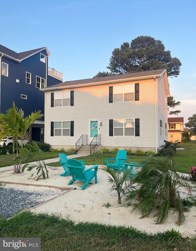 rear view of house with a lawn