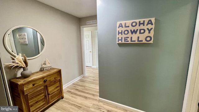 corridor with light hardwood / wood-style floors