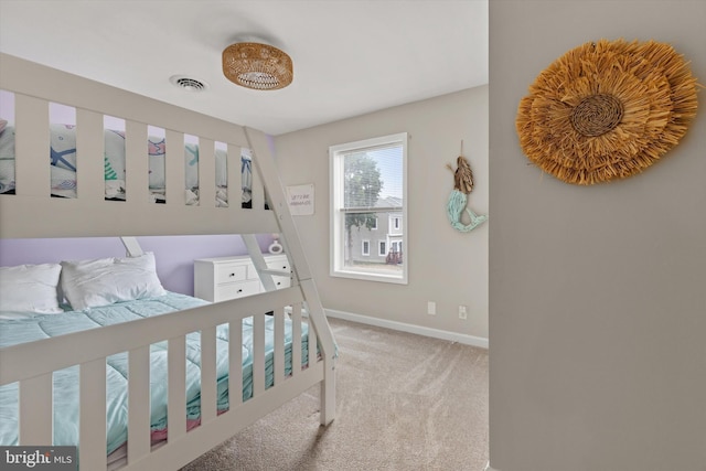 bedroom featuring visible vents, light colored carpet, and baseboards