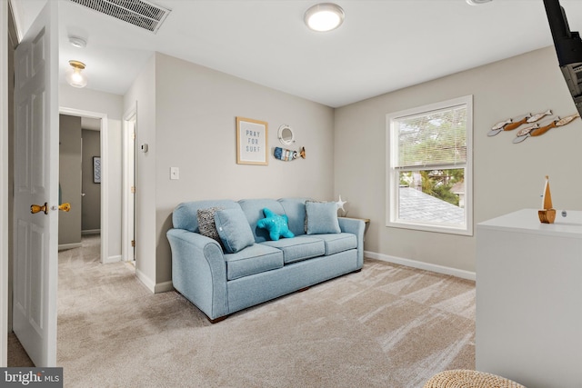 living room with visible vents, baseboards, and carpet floors