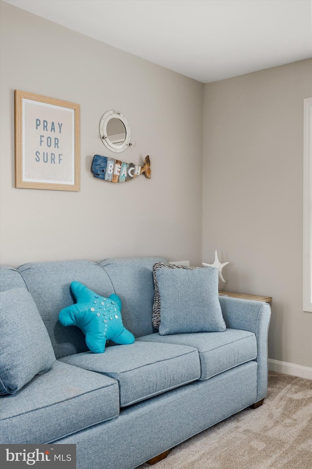 living room with carpet and baseboards