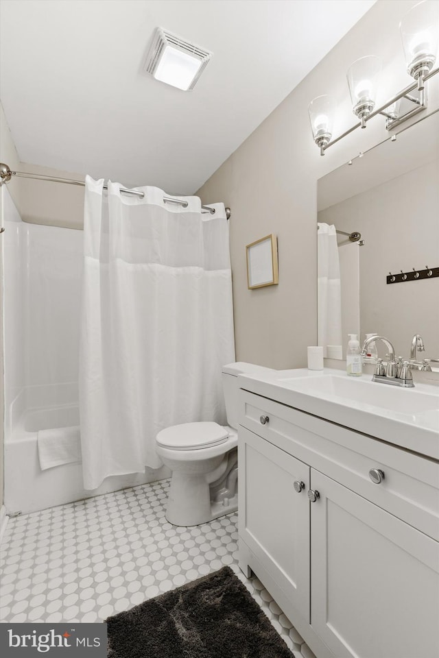 bathroom featuring vanity, toilet, shower / bathtub combination with curtain, and visible vents