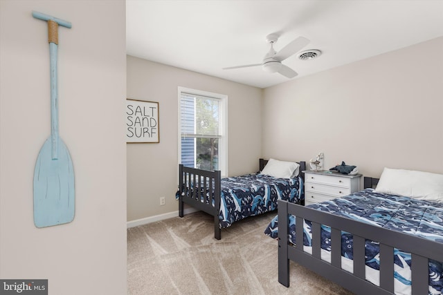 bedroom featuring a ceiling fan, baseboards, visible vents, and light carpet