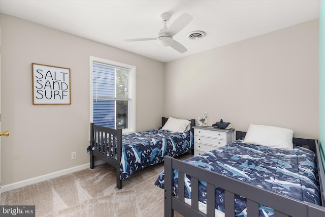 bedroom with visible vents, carpet floors, baseboards, and a ceiling fan