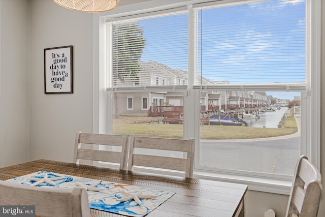 dining area featuring a wealth of natural light and a water view