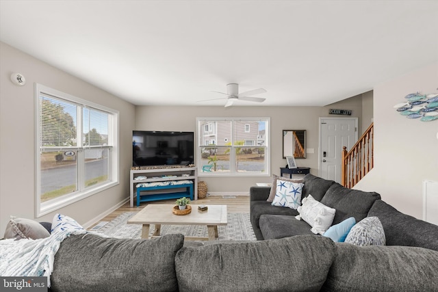 living room featuring light hardwood / wood-style flooring and ceiling fan