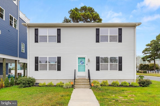 view of front of home featuring a front yard and entry steps