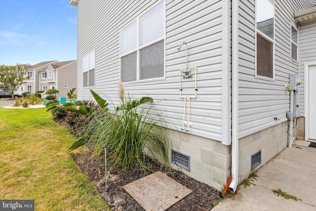 view of home's exterior with a yard, a residential view, and crawl space