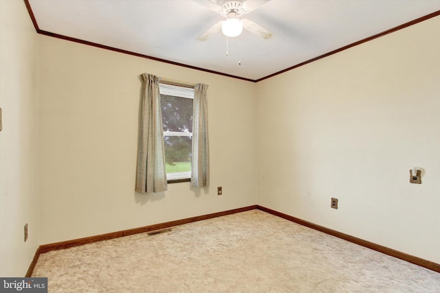 carpeted empty room with ornamental molding and ceiling fan