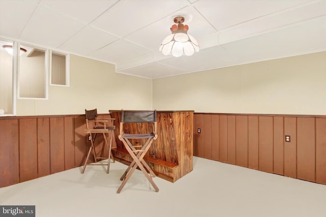 interior space featuring wooden walls and indoor bar