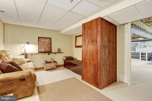 living room with a paneled ceiling