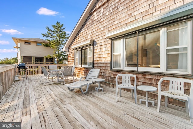 wooden deck featuring outdoor dining area