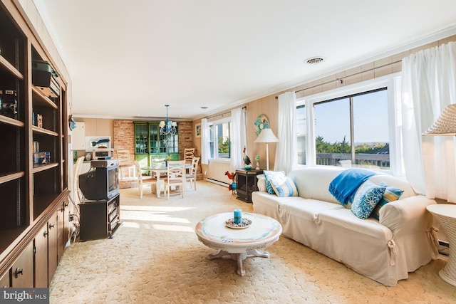 living room featuring a chandelier, ornamental molding, brick wall, light colored carpet, and baseboard heating