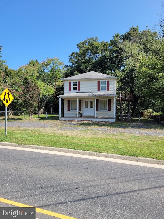 view of front of property with covered porch and a front lawn