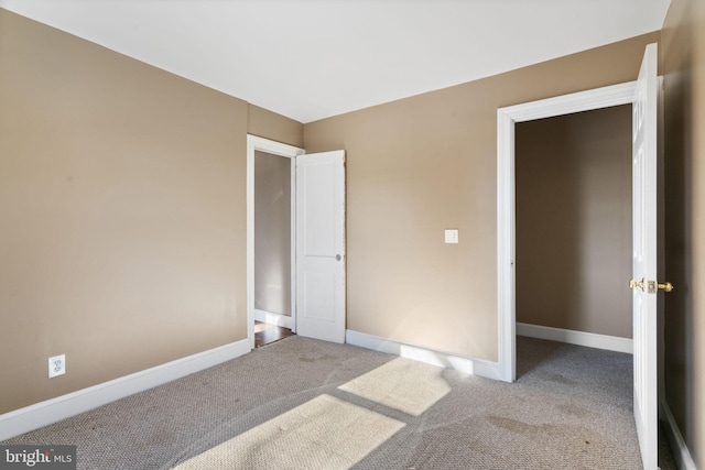 unfurnished bedroom featuring baseboards and carpet floors