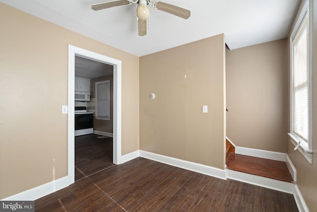 unfurnished room featuring plenty of natural light, baseboards, and wood finished floors