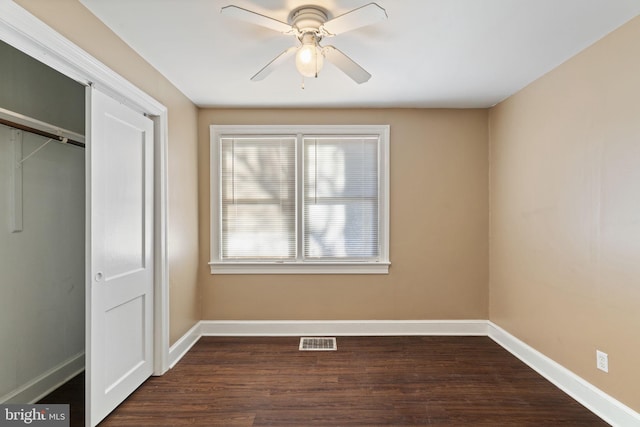 unfurnished bedroom with visible vents, baseboards, a closet, and dark wood finished floors