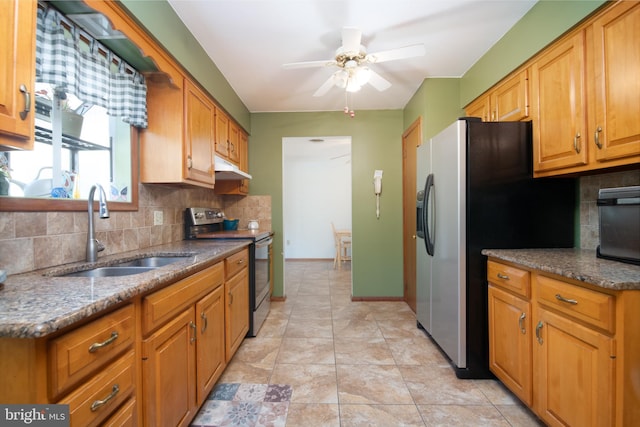 kitchen with stainless steel appliances, backsplash, a sink, and under cabinet range hood