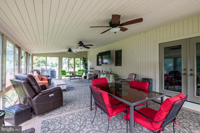 sunroom featuring french doors, plenty of natural light, and wooden ceiling