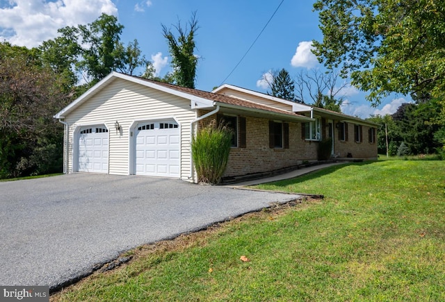 view of front facade with a front yard and a garage