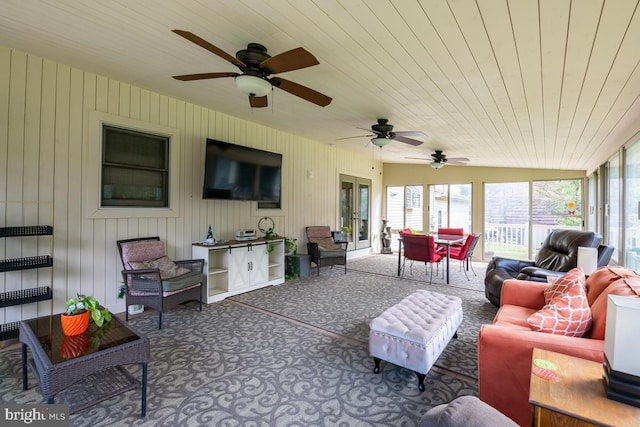 exterior space featuring lofted ceiling, ceiling fan, and wood ceiling