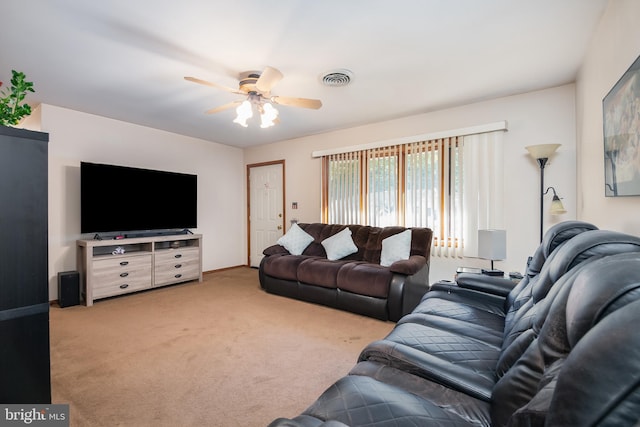 living room with visible vents, carpet flooring, a ceiling fan, and baseboards