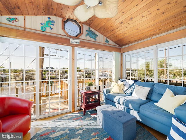 sunroom / solarium with lofted ceiling, ceiling fan, and wooden ceiling