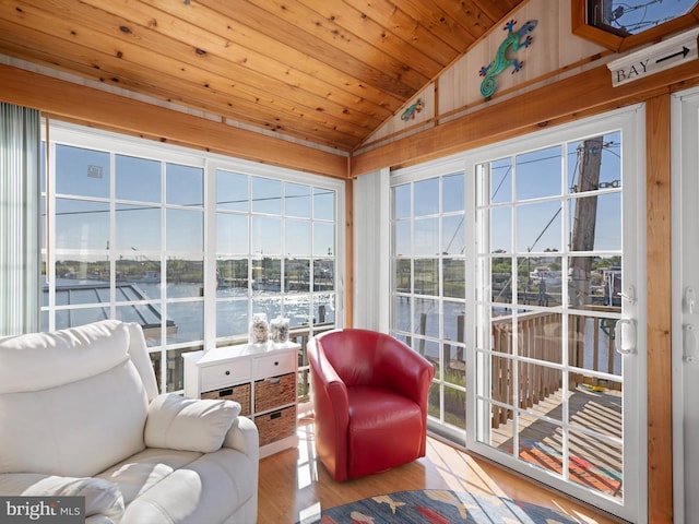 sunroom featuring wood ceiling, lofted ceiling, a water view, and a healthy amount of sunlight