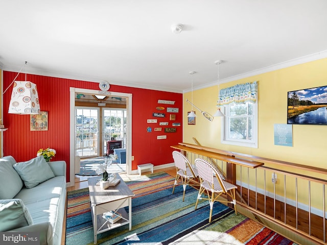 living room featuring a wealth of natural light and crown molding