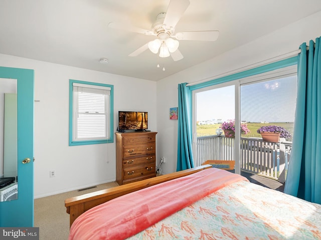 carpeted bedroom with ceiling fan and access to outside