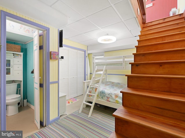 bedroom with a closet and a paneled ceiling