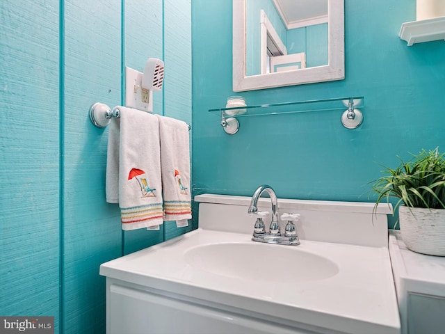 bathroom with ornamental molding and vanity