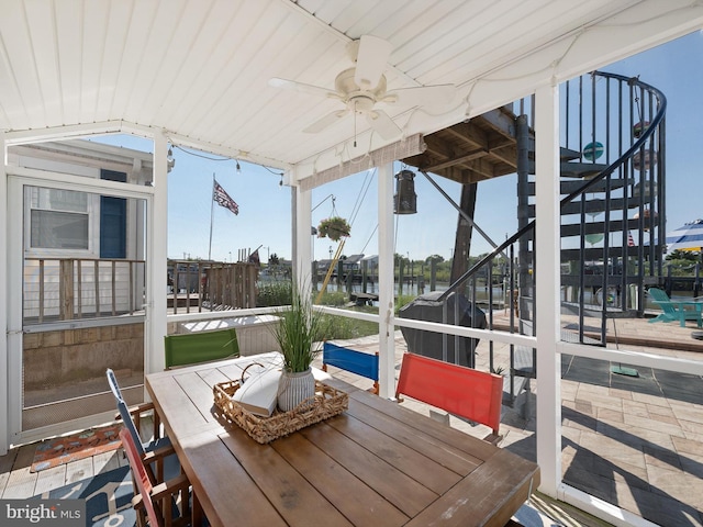 exterior space featuring vaulted ceiling, a water view, and ceiling fan