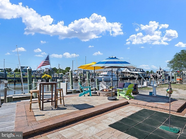 exterior space featuring a fire pit and a water view