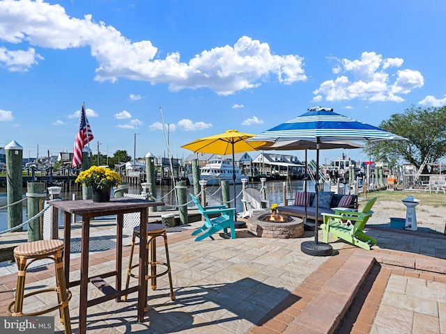 view of patio featuring a fire pit and a water view