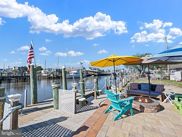 dock area featuring a water view, a patio, and an outdoor fire pit