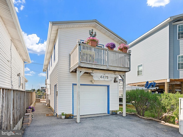 view of front facade with a balcony and a garage