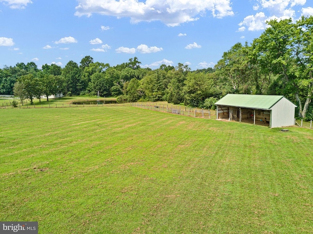 view of yard with a rural view and an outdoor structure