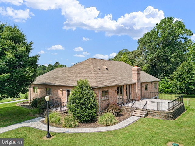 rear view of property featuring a lawn and a patio