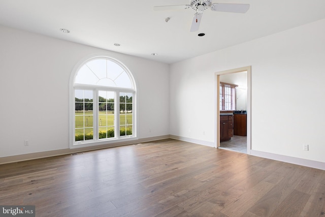 spare room featuring ceiling fan and light hardwood / wood-style flooring