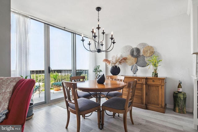 dining area with a chandelier and light hardwood / wood-style flooring