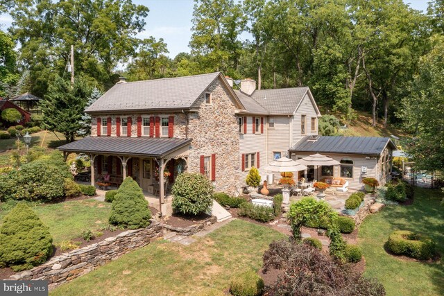 view of front of house with a front yard and a patio