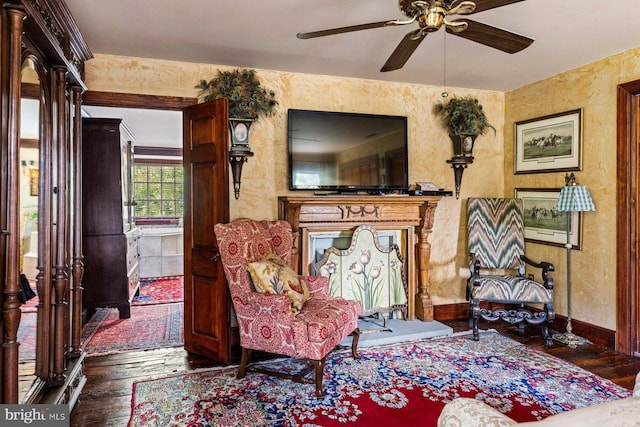 living area featuring ceiling fan and hardwood / wood-style flooring