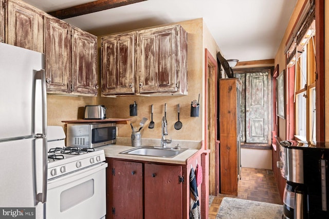 kitchen with sink, stainless steel appliances, and parquet floors