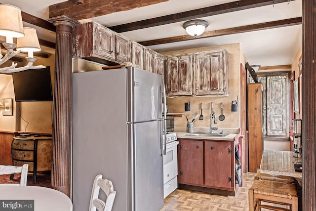 kitchen featuring light parquet flooring, ornate columns, sink, beamed ceiling, and white appliances