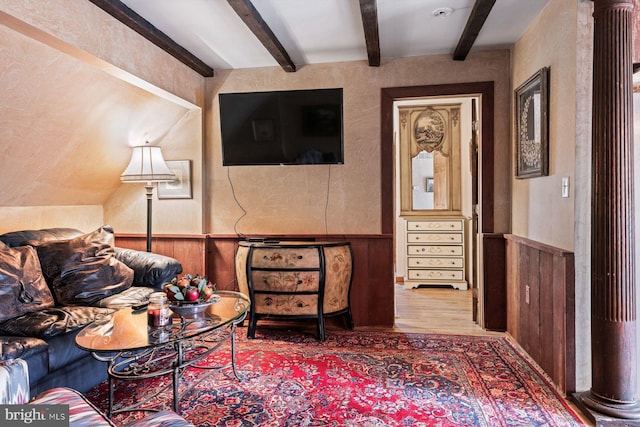 sitting room featuring beamed ceiling and wood-type flooring