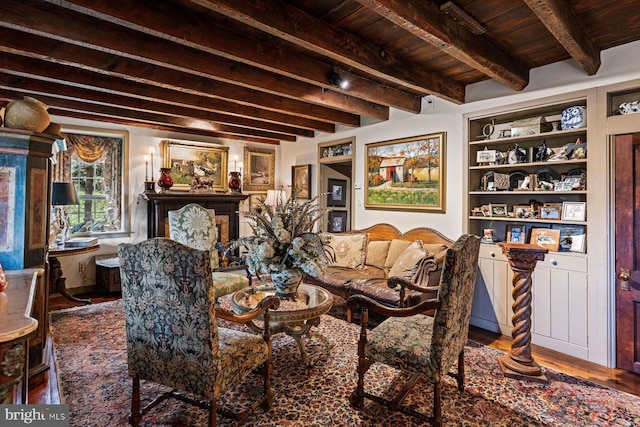 living room featuring wooden ceiling, beam ceiling, hardwood / wood-style flooring, and built in shelves