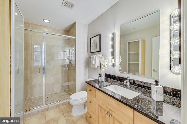 bathroom with vanity, toilet, walk in shower, and tile patterned floors